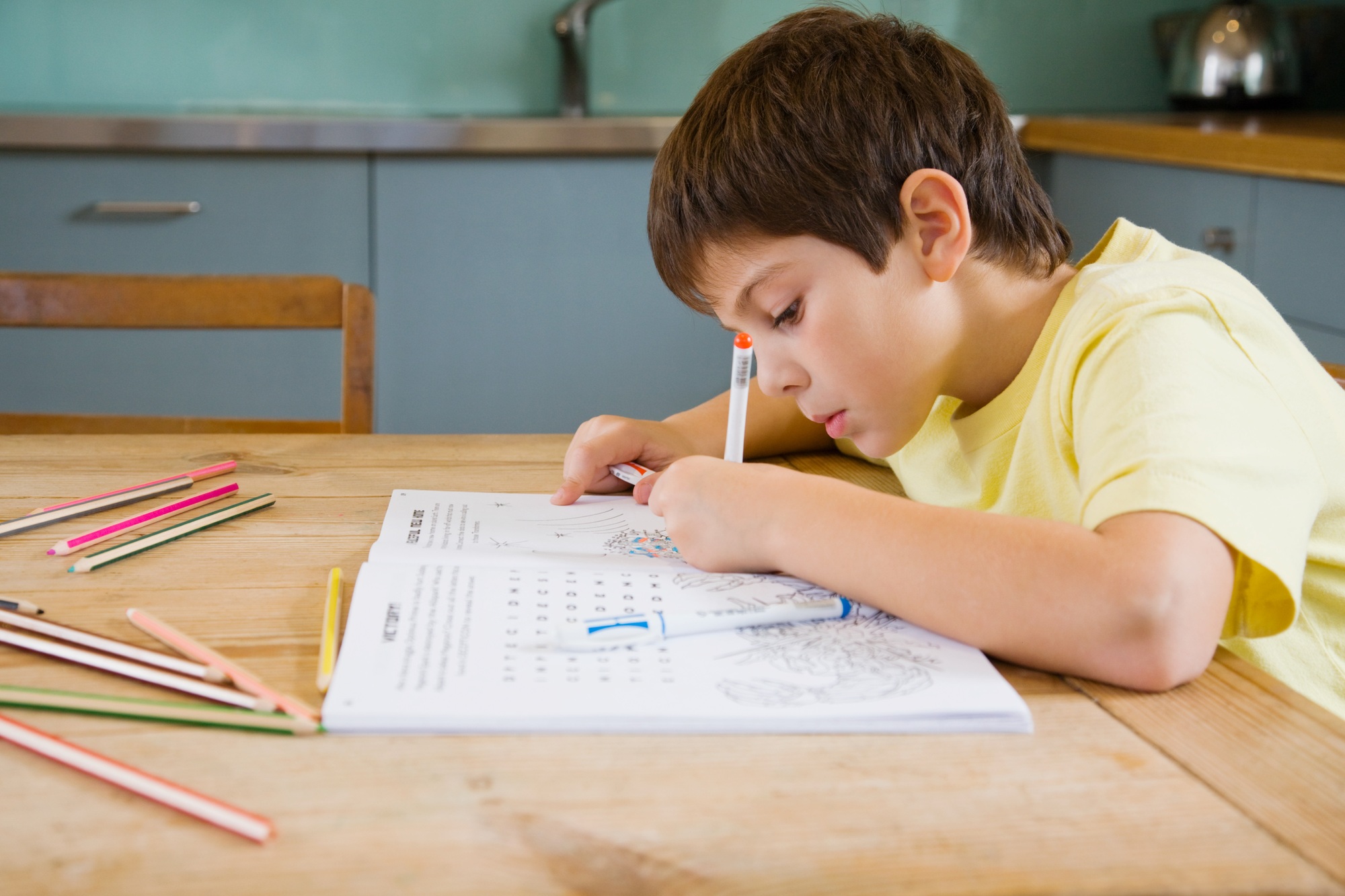 A boy colouring in