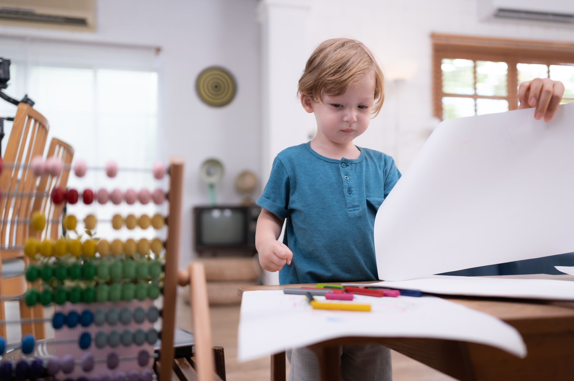 A little child's imagination is represented through colored pencil drawings,